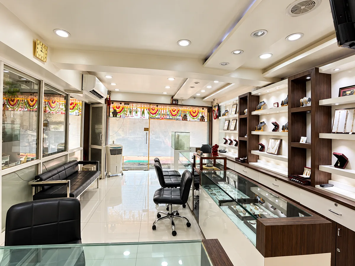 Inside the Drashti Jewels showroom — lit glass counters and wall displays